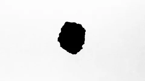 Black ink drops splatters spilling on white background Stock Footage 125476802