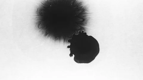Black ink drops splatters spilling on white background Stock Footage 125477388