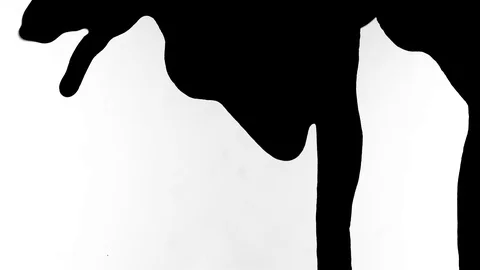 Black ink drops splatters spilling on white background Video stock 125477442