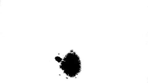Black ink drops splatters spilling on white background Stock Footage 125477523