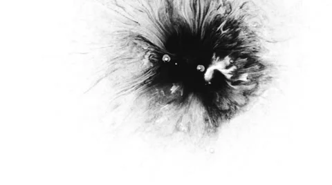 Black ink drops on white paper background Stockbeeldmateriaal 37117174