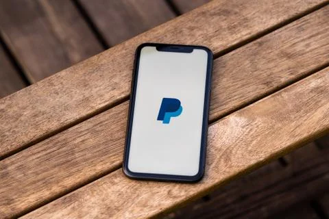 Black iphone with logo of PayPal application on the screen. Stock Photos