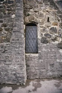 Black iron door with handle in ancient stone wall Stock Photos