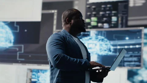 Black IT engineer working in a digital environment with programming language Stock Footage 312413818
