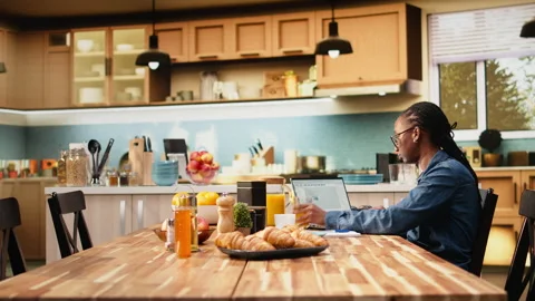 Black IT engineer working remotely coding on laptop and programming scripts Vídeos de archivo 344243961
