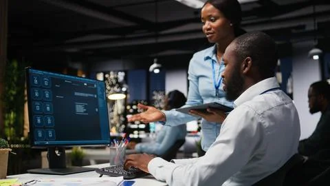 Black IT engineers team developing app and software algorithm on pc 写真素材