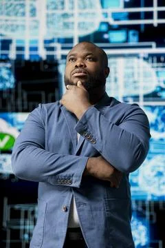 Black IT professional coding for futuristic AI brain blueprints in background Foto stock