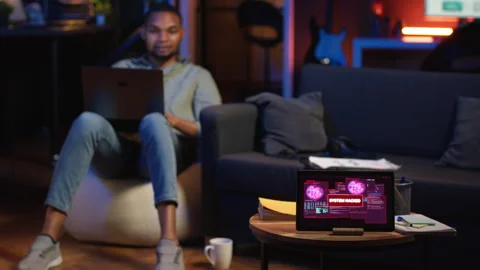 Black IT professional in loft working on cybersecurity with gadgets Stock Footage 308333060