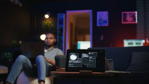 Black IT professional in loft working on cybersecurity with gadgets Stock Footage 308333981