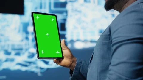 Black IT specialist examining algorithmic data next to chroma key Stock Footage 312477707