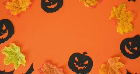 Black jack-o'-lanterns, bats, fall leaves and place for text Stock Footage 344980608