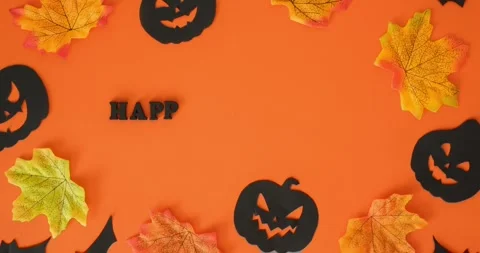 Black jack-o'-lanterns, bats, fall leaves and "Happy Halloween" text Stock Footage 344980612