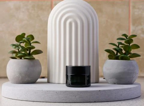 Black jar for cosmetics on a white table. Packaging for cream, gel, serum, .. Stock Photos