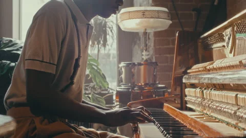 Black Jazz Performer Playing Open Upright Piano in Sunlit Retro Bar Stock Footage 303695410
