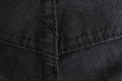 Black jeans texture with sewing pattern  back side, abstract close up backdro Foto stock