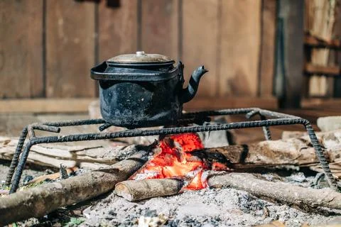 Black kettle cooking over an open wood fire Stock Photos