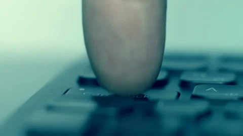 On the black keyboard, the finger presses the keys Caps Lock, Windows, Space Stock Footage 130545752