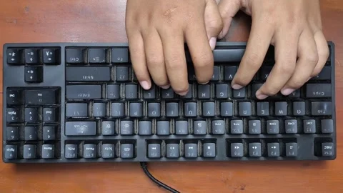 Black keyboard sits on wooden surface Stock Footage 339324152