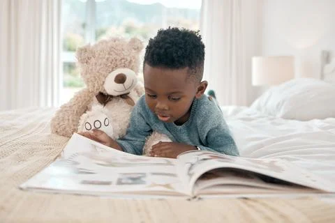 Black kid, learning and reading book in home bedroom, storytelling and knowledge Stock Photos