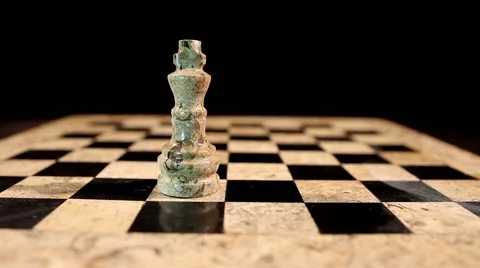 A black king hits a white king on an empty chess board, isolated on black 스톡 동영상 58417638