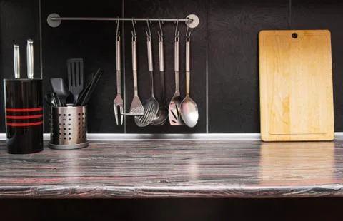 Black kitchen with kitchen utensils Stock Photos