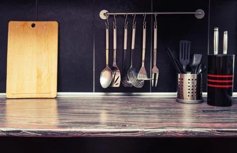 Black kitchen with kitchen utensils Stock Photos