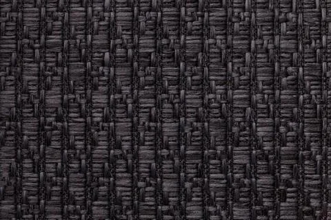 Black knitted woolen background with a pattern of soft, fleecy cloth. Texture Stock Photos