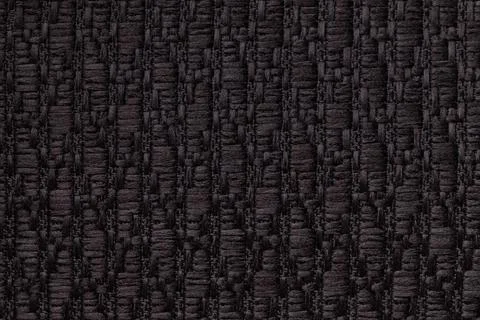 Black knitted woolen background with pattern of fleecy cloth. Texture of text Stock Photos