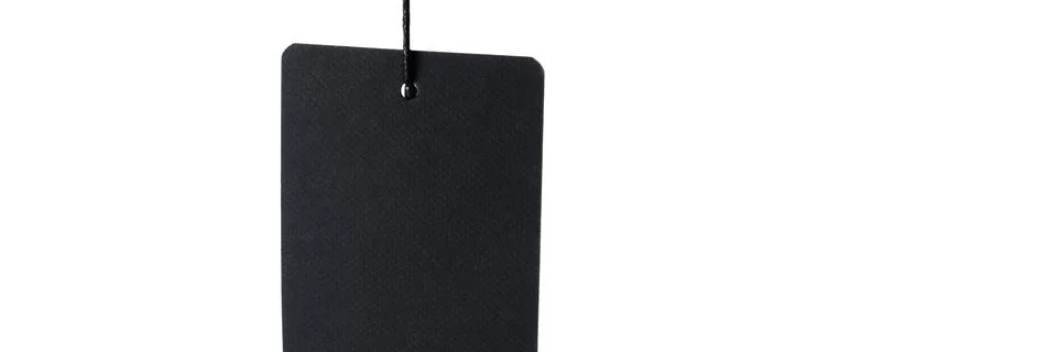Black label on thread on white background, isolated. Stock Photos