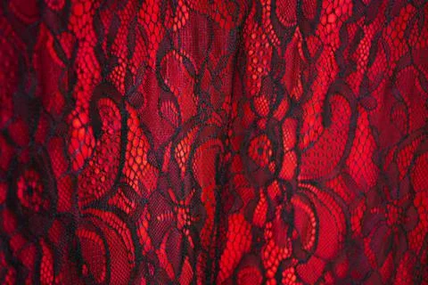 Black lace on red fabric background texture Foto stock