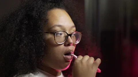 Black lady brushing her teeth in her bathroom. Stock Footage 221026561