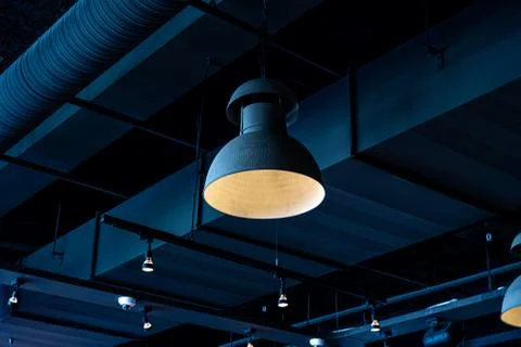 Black lamp hanging from the ceiling. Interior decoration of stylish bar. Mode Stock Photos