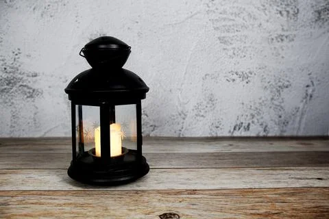 Black Lantern with LED candle light home decoration on wooden background Stock Photos