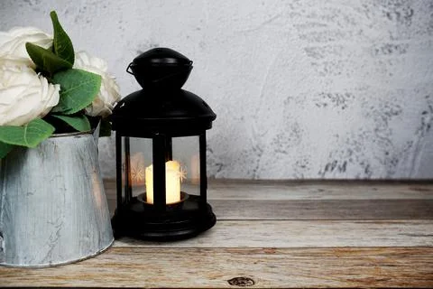 Black Lantern with LED candle light home decoration on wooden background Stock Photos