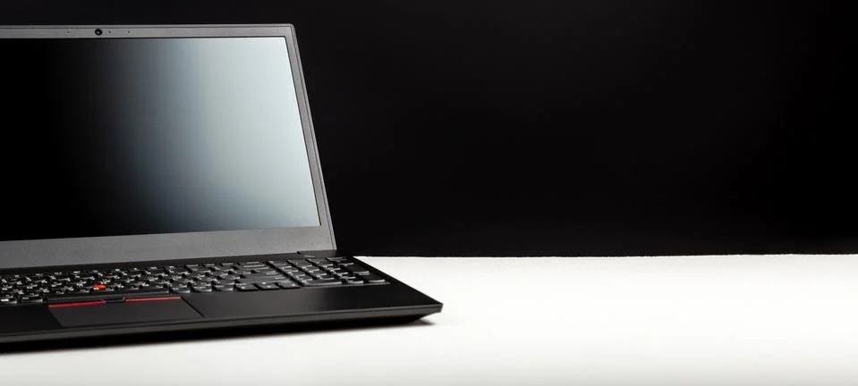 Black laptop with blank display layout template on white table Black backgrou Stock Photos