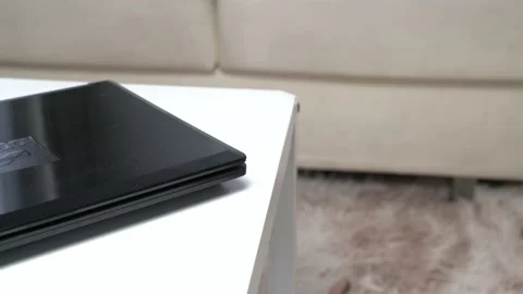 A black laptop on a white table Video stock 163863249