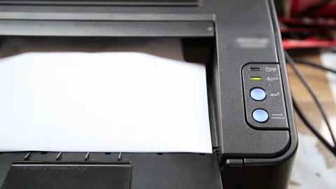 Black laser printer producing document copy with sheet of paper feeding through Stock Footage 329213284