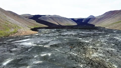 Black lava rocks flowing through a mountain valley in iceland Видео 279722209