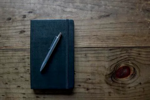 Black Leather Bound Notebook with Silver Pen Stock Photos