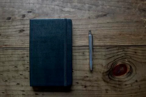 Black Leather Bound Notebook with Silver Pen Stock Photos