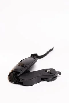 Black leather camera strap on white background Stock Photos