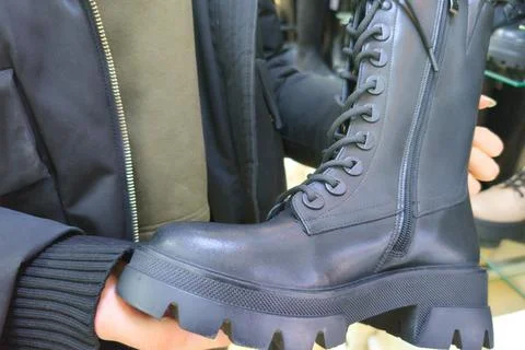 Black leather combat boot with thick sole Stock Photos