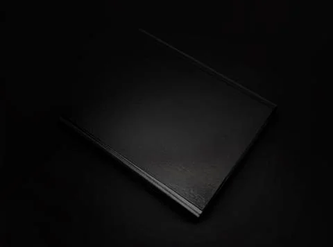 Black leather folder isolated on black background Stock Photos