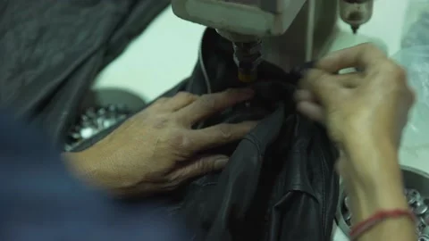 Black leather jacket button set in factory 動画素材 202458430