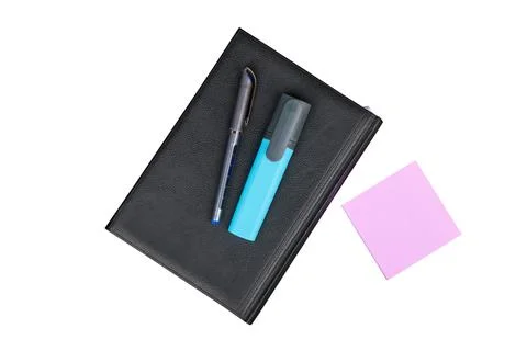 Black leather notebook with a pen and marker, isolated on white background Stock Photos