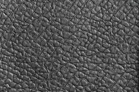 Black leather sofa, pattern surface texture. Close-up of interior material fo Stock Photos