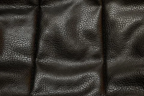 Black leather texture with a characteristic grain pattern and surface shine,  Stock Photos