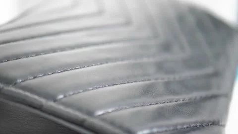 Black leather texture extreme close up with a sliding camera move professional Stock Footage 201813673