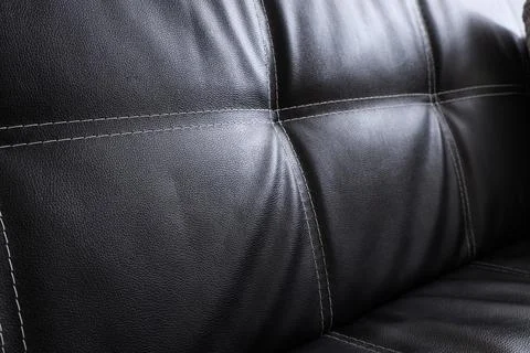 Black leather texture with white stitching, upholstery detail on furniture, m Stock Photos