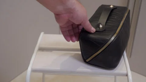 Black Leather Vanity Case Pushed Gently Across White Wooden Shelf. Stock Footage 321436890
